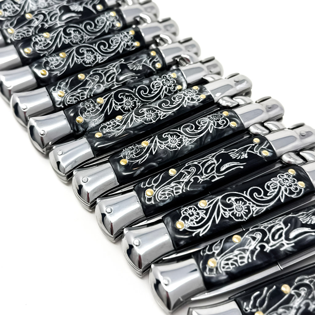 Pair of black-handled pocket knives with silver blades on a white background